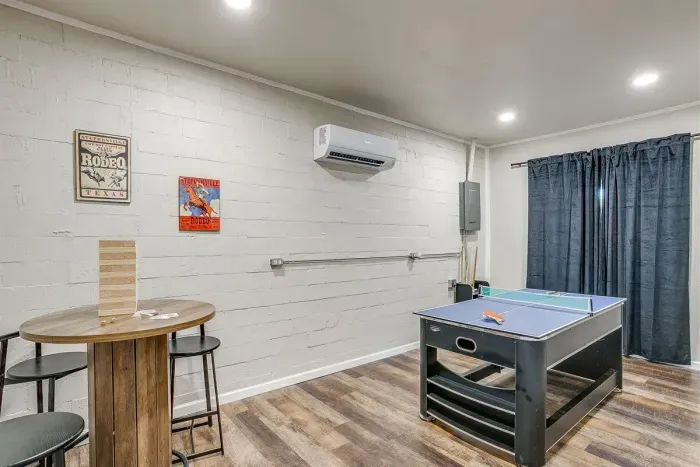 Game room with ping pong table, AC unit, and room to gather and play