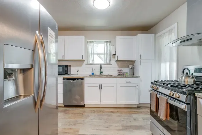 Modern kitchen with quartz counters, subway tile, and new appliances