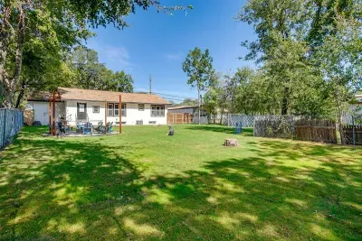 Perfect for gatherings—shaded trees and play space in a quiet, fenced backyard