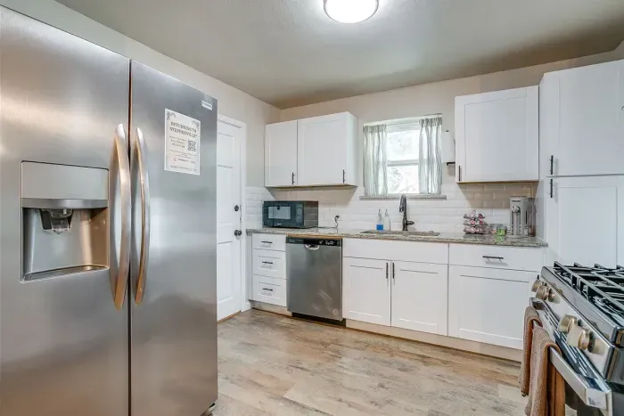 Fully stocked kitchen with stainless steel fridge and everything you need