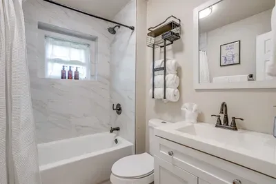 Freshly renovated bathroom with stylish tile and stocked with all essentials