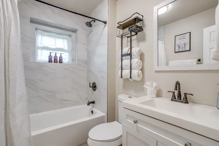 Freshly renovated bathroom with stylish tile and stocked with all essentials