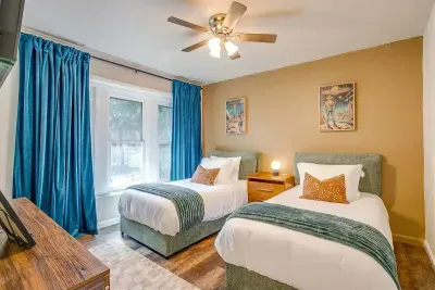 Fun twin bedroom with playful alien decor, bright windows, and luxury bedding