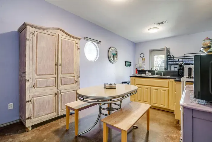 Comfortable dining setup with rustic charm, located between the kitchen and living area for easy access.