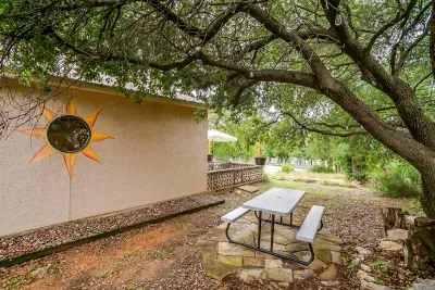 Picnic table nestled under the large oak tree provides a quiet, shaded spot for lunch or a relaxing afternoon outside.
