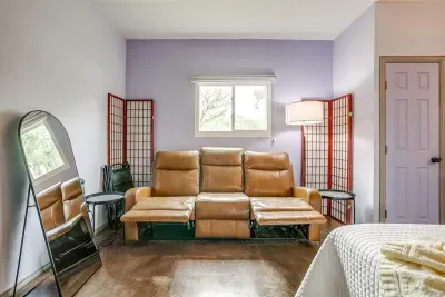 Recliner couch offers additional comfort for lounging, reading, or relaxing indoors after a full day outdoors.