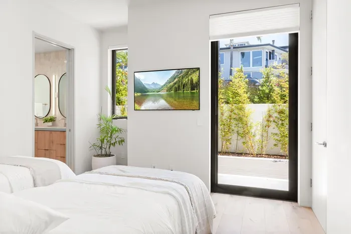 Guest bedroom 1 with smart TV and ensuite bathroom - main floor