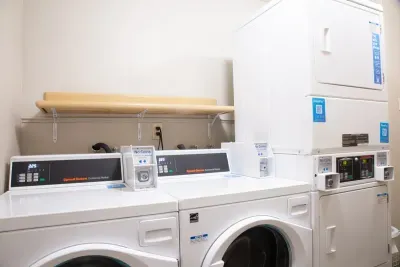 Laundry room is across the hall and you can do 2 loads at once :)