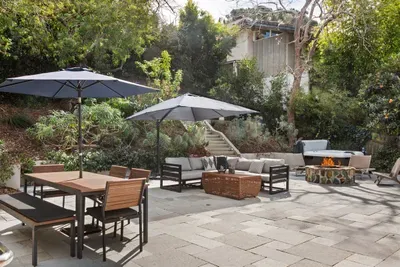 Back yard equipped with a bbq, hot tub, and fire pit