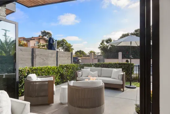 Private gated patio with a fire pit