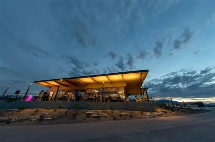 Modern open-air clubhouse with glowing sunset ambiance