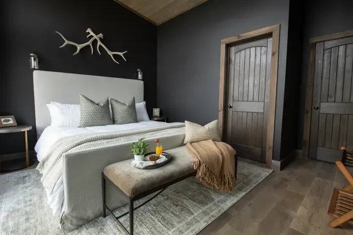A romantic master suite with mountain views and a private deck featuring a warm outdoor fireplace