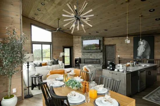 Spacious open-concept living, dining, and kitchen area designed for connection, complete with a stylish electric fireplace