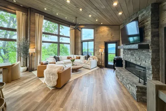 Floor-to-ceiling mountain views paired with a warm, cozy fireplace create the ultimate retreat