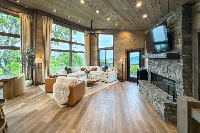 Floor-to-ceiling mountain views paired with a warm, cozy fireplace create the ultimate retreat