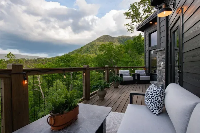 Enjoy the upper deck with a cozy outdoor fireplace and grill, perfect for relaxing and dining with a view
