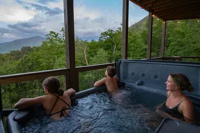 Soak in the hot tub while taking in breathtaking mountain views