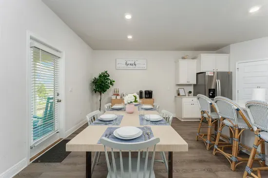 Gather for meals at the roomy dining table for six, with the kitchen island nearby offering four more cozy seats—perfect for family and friends