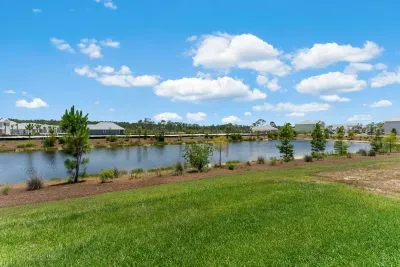 Step into your own peaceful escape — the backyard overlooks a quiet pond, surrounded by coastal breezes. It’s the perfect place to sip your morning coffee or unwind after a sun-soaked day at the beach.