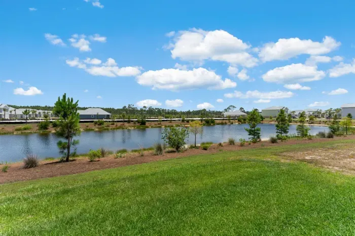 Step into your own peaceful escape — the backyard overlooks a quiet pond, surrounded by coastal breezes. It’s the perfect place to sip your morning coffee or unwind after a sun-soaked day at the beach.