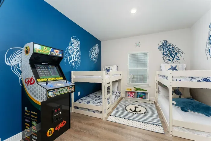 Fun kids’ room with an arcade game and 42" TV—perfect for downtime after the beach