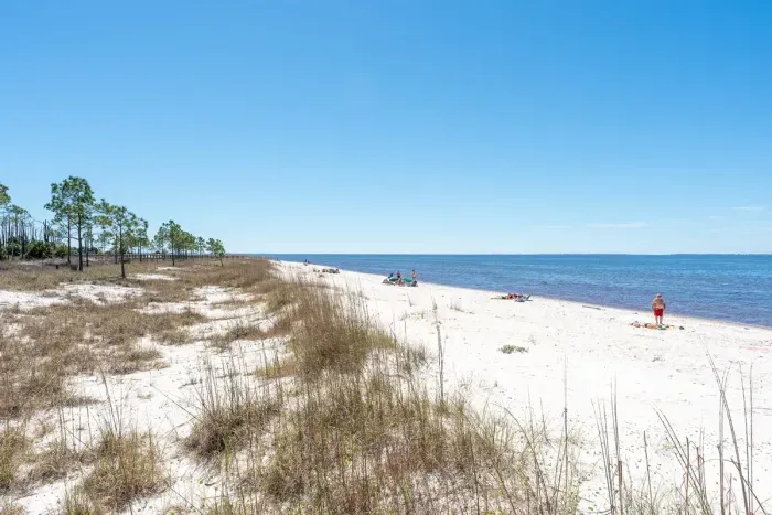 Only 5 minutes' walk to the pristine shores of St. Joe Beach, where white sand meets unforgettable sunsets