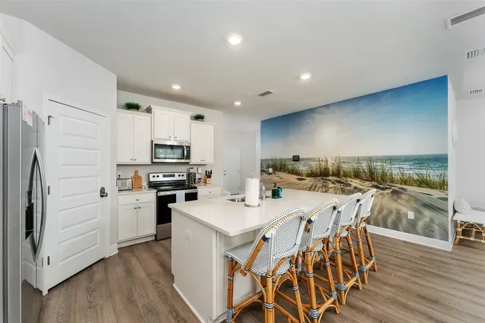 Enjoy a relaxed morning at the oversized kitchen island, perfect for sipping coffee and planning your beach day