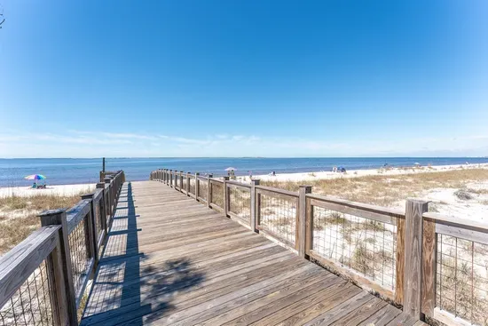 A charming boardwalk connects the pool area to the stunning white sand beach for ultimate convenience