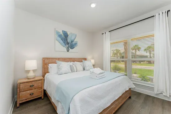 The bedroom features a plush king-size bed and a flat-screen TV—perfect for winding down in comfort
