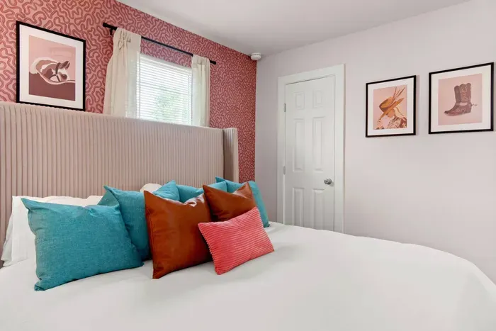 Second King bedroom with Roku TV, large closet with hangers, portable fan, and full length mirror