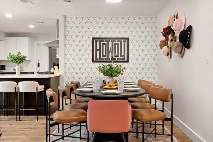 Indoor dining area with large table and hat gallery wall