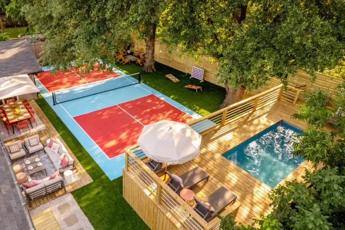 Backyard with pool and pickleball court at Cowgirl Casa, a group-friendly Austin luxury rental