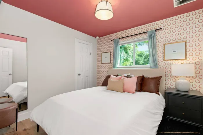 The Horseshoe Room featuring a queen bed, Roku TV, large closet with hangers, portable fan, and full length mirror
