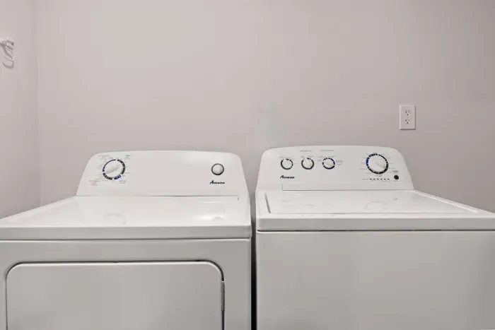 Washer & dryer with laundry detergent pods, iron, and ironing board