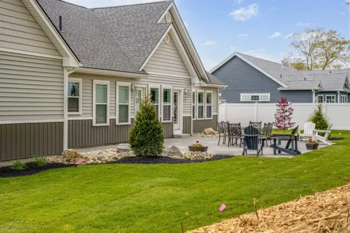 Enjoy the expansive outdoor space with a sunny lawn, patio dining set, Adirondack chairs, and a grill—perfect for barbecues, relaxing afternoons, and memorable evenings with friends and family.