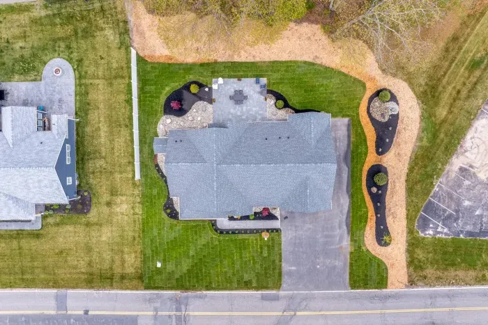 Enjoy the expansive outdoor space with a sunny lawn, patio dining set, Adirondack chairs, and a grill—perfect for barbecues, relaxing afternoons, and memorable evenings with friends and family.