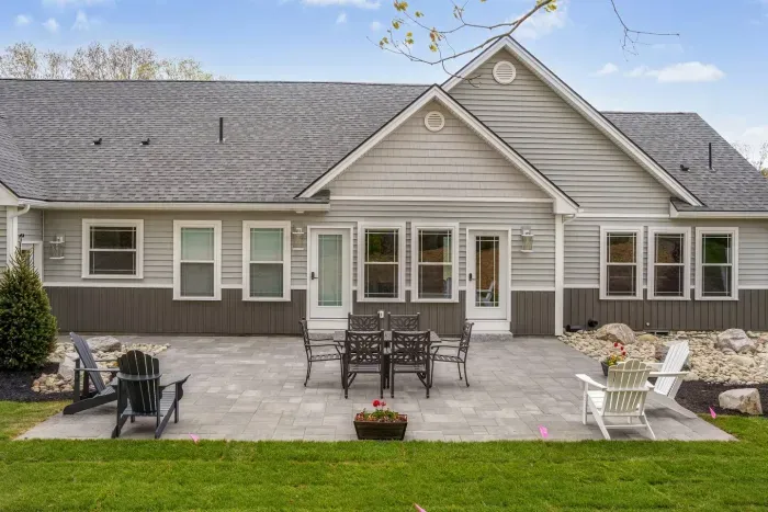 Enjoy the expansive outdoor space with a sunny lawn, patio dining set, Adirondack chairs, and a grill—perfect for barbecues, relaxing afternoons, and memorable evenings with friends and family.
