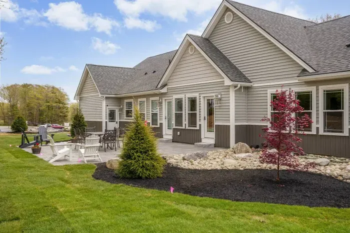 Enjoy the expansive outdoor space with a sunny lawn, patio dining set, Adirondack chairs, and a grill—perfect for barbecues, relaxing afternoons, and memorable evenings with friends and family.