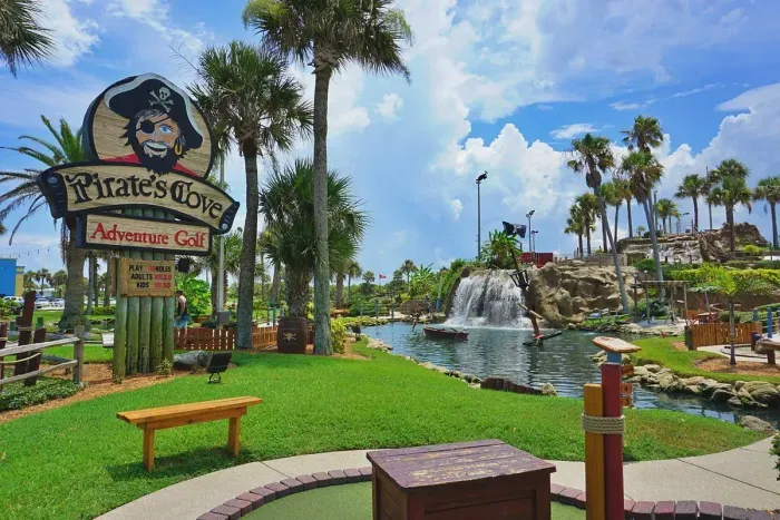 Tropical pirate-themed mini golf with waterfalls and palm-lined views