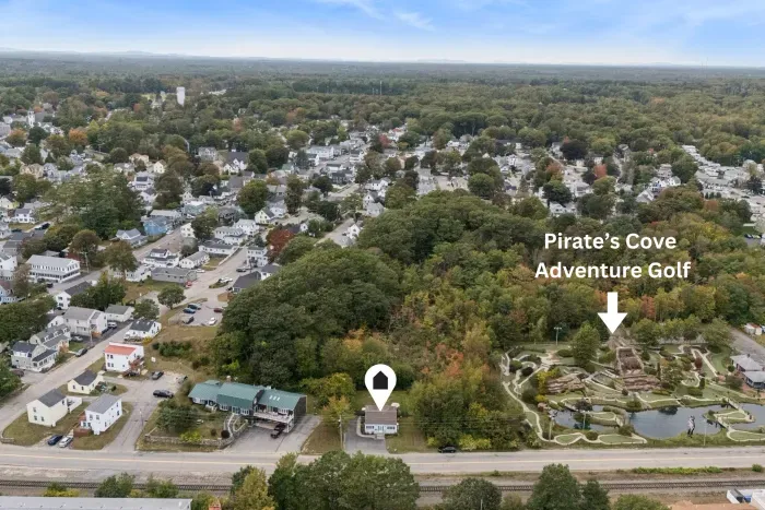 Aerial view near Pirate’s Cove Adventure Golf in a leafy neighborhood
