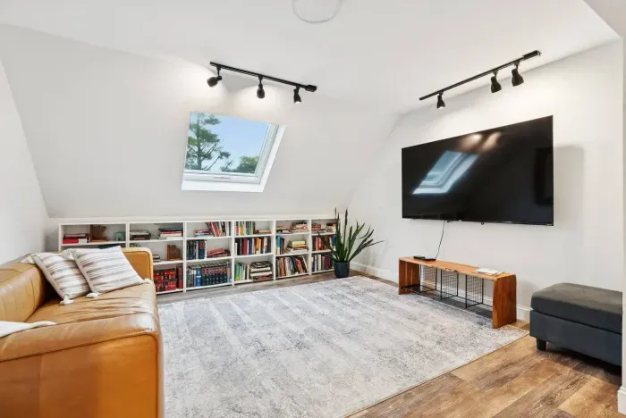 Lounge in the beautiful light filled living room. Equipped with Roku TV (use your logins for apps) and an endless supply of books to cozy up and relax. 