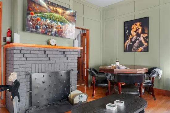 Gather around the fireplace and enjoy the modern entertainment setup, including a flat-screen TV and cozy accents. The room blends classic and contemporary styles seamlessly.