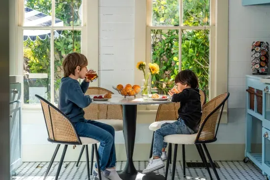 Little guests can enjoy a casual meal at the sunny kitchen table, surrounded by the warmth and charm of this thoughtfully curated space.
