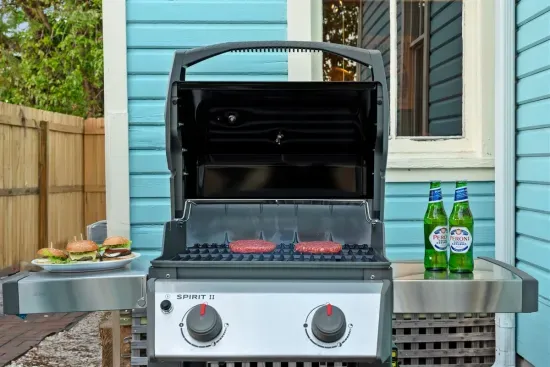 The BBQ grill is ready for a feast! Fire it up for family cookouts or casual outdoor dining with burgers and refreshing drinks.