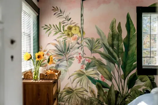 Wake up to the vibrant jungle decor of Bedroom 2, with its bold, colorful pillows and inviting bed.