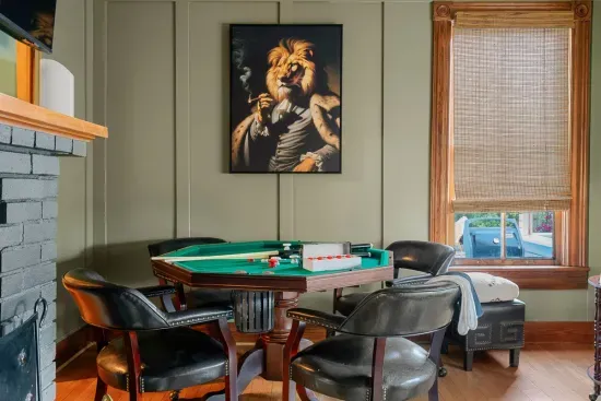 A stunning push snooker table doubles as a poker table, making the Gentleman’s Room a hub for fun and games. The bold lion portrait adds a whimsical yet refined touch.