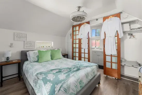 The serene queen bedroom, complete with soft linens and modern decor, promises a restful night.
