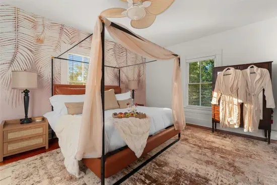 The elegant four-poster bed in Bedroom 3 is draped with flowing canopy fabric for a serene ambiance.