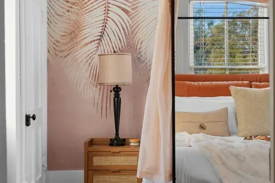 Soft blush and neutral tones create a tranquil escape in this luxurious king suite.