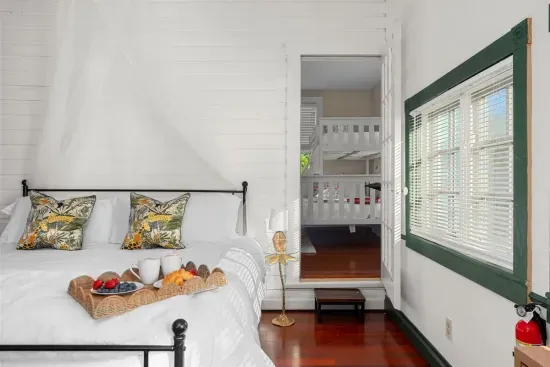 This room's unique style is complemented by soft white linens and a touch of greenery.